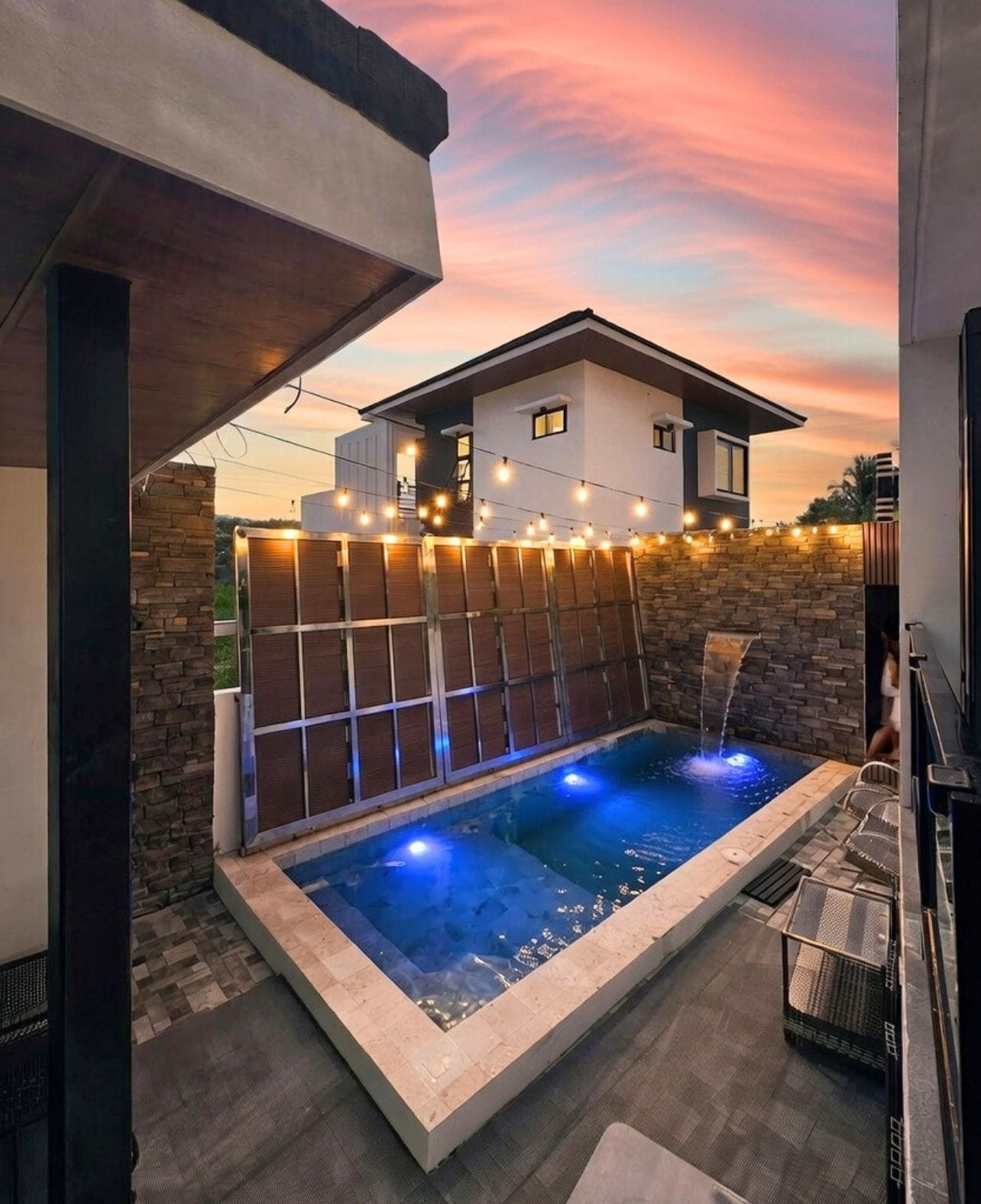 Private pool with waterfall at sunset