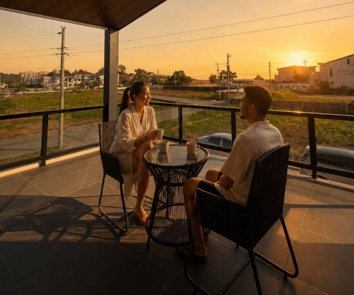 Couple enjoying sunset at Peter & Jade Beach House balcony